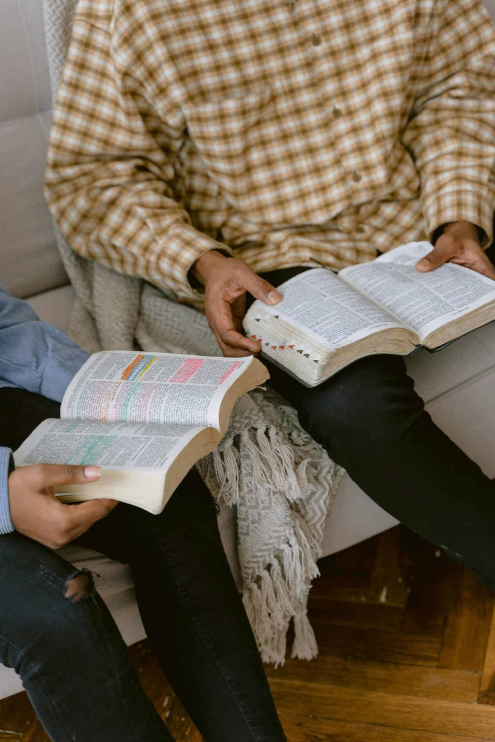 person in white long-sleeved shirt holding book